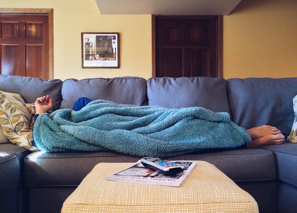 person relaxing at home while rewatching a familiar movie